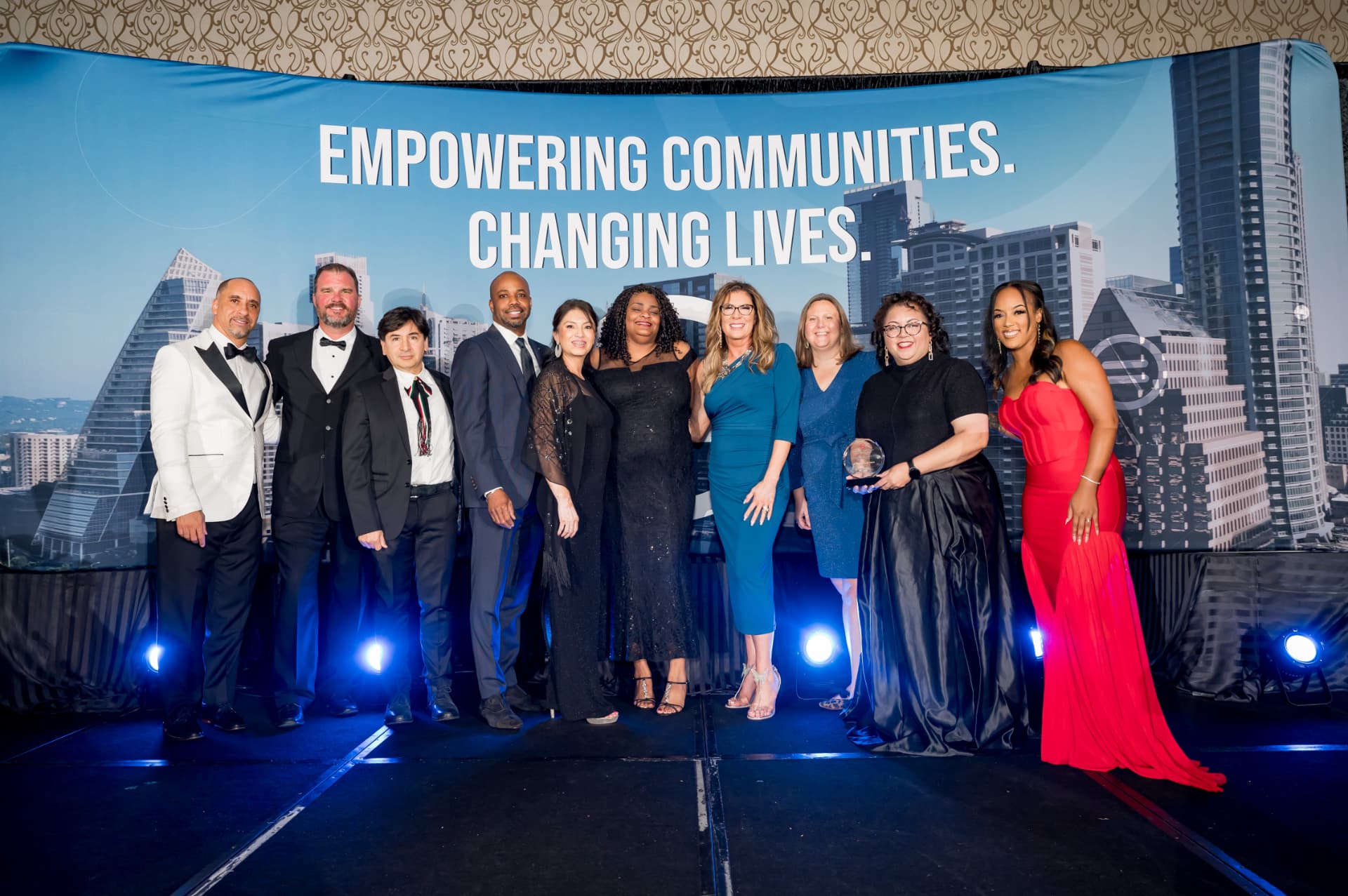 Award recipients posing together on stage at a gala