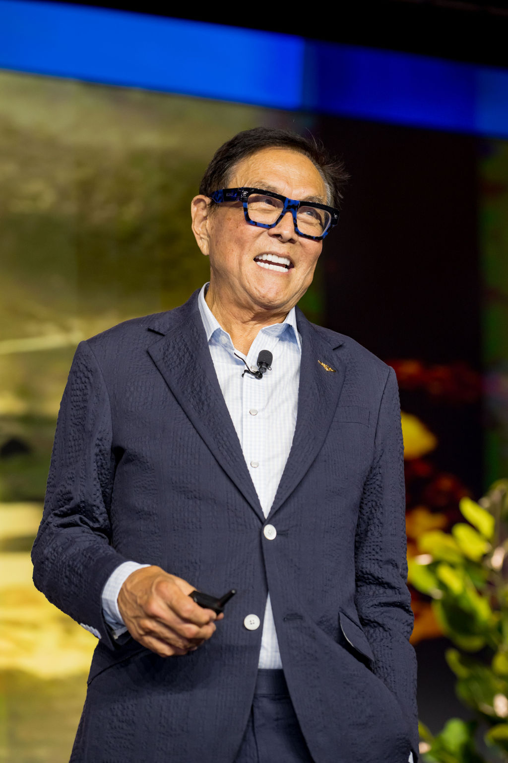 Smiling keynote speaker mid-presentation on the Limitless Expo main stage