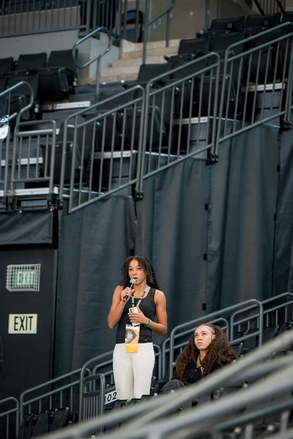 Attendee speaking into the microphone from the arena seating