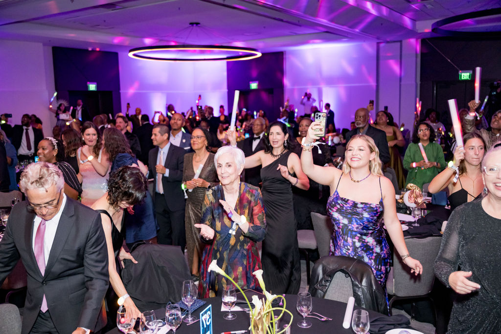 Guests dancing and filming during the celebration