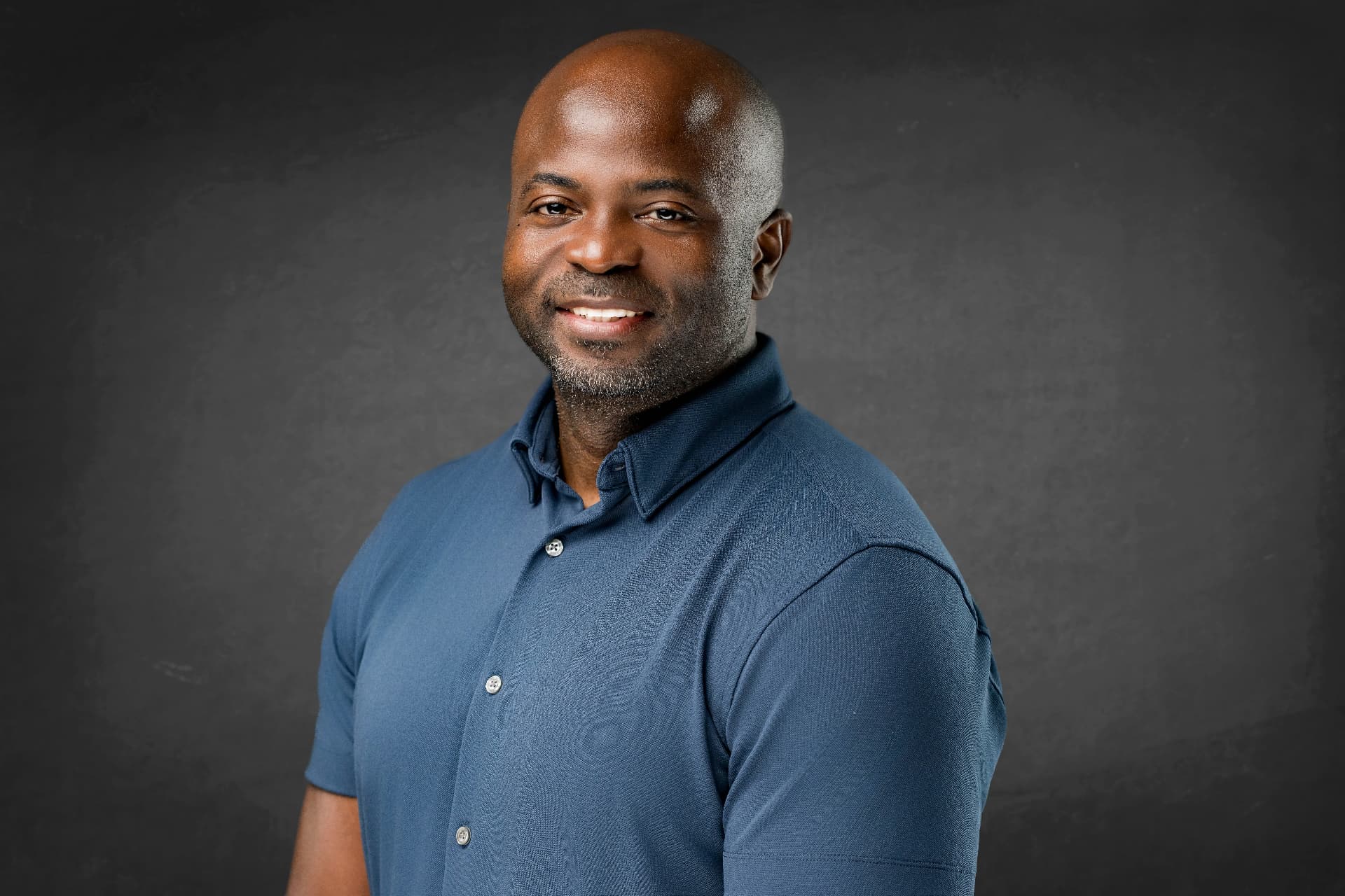 Portrait of the Creative Event Photography founder in a blue polo shirt