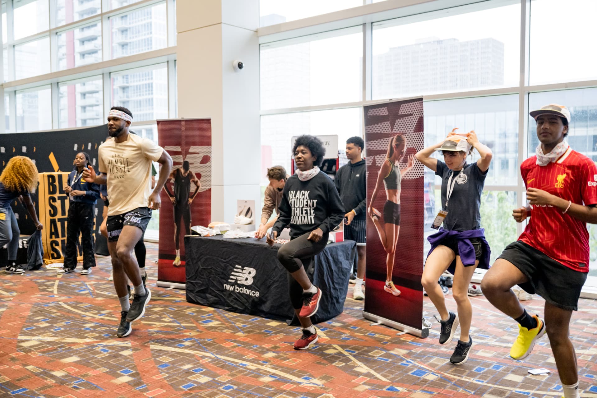 Participants jogging in place beside sponsor banners