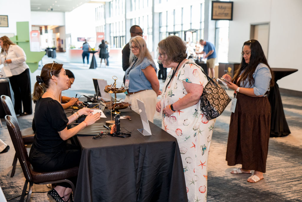 Attendees checking in at the conference help desk in the venue lobby