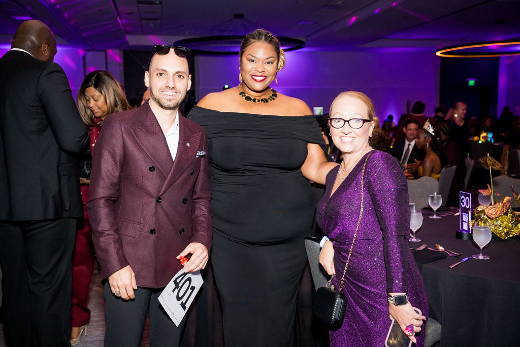 Three guests posing together during the gala reception