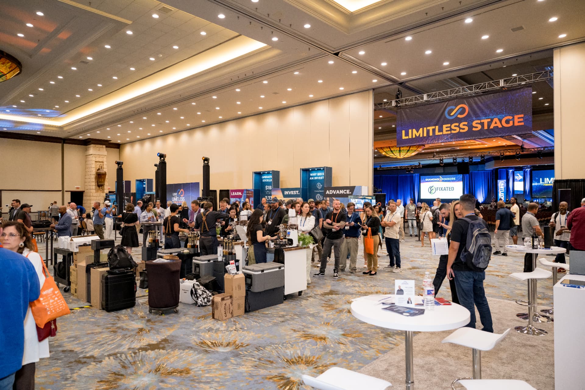 Attendees gathered near the Limitless Stage and coffee bar during a break