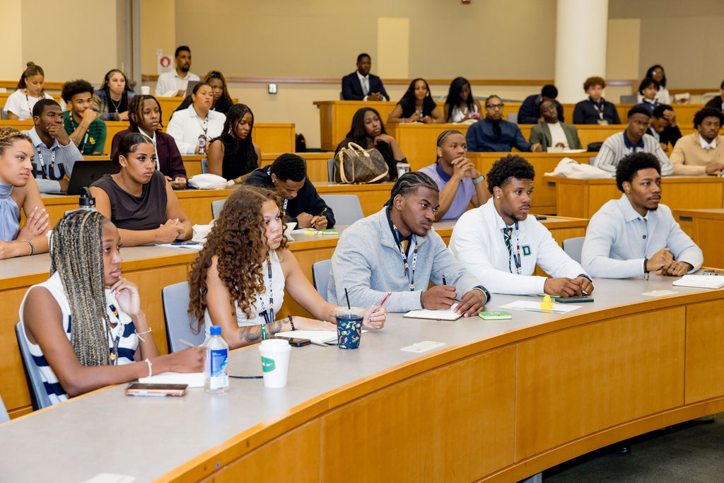 Lecture hall filled with student-athletes taking notes