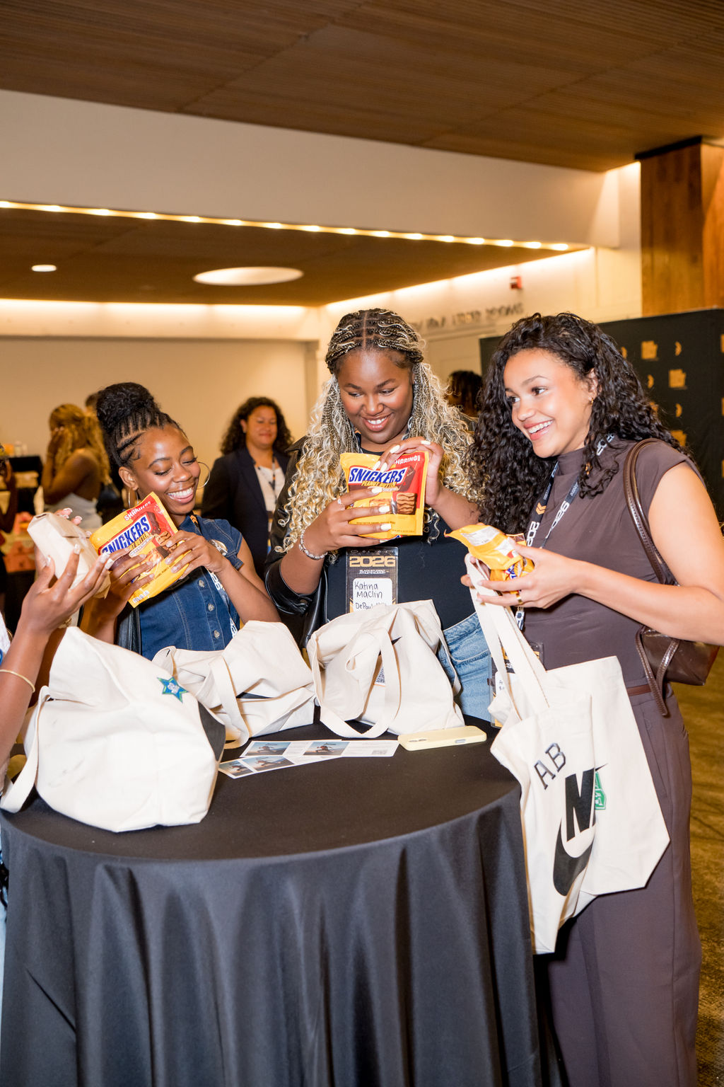 Attendees collecting snacks and tote bags at the BSA Summit
